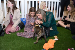 A woman and a child with a puppy at BC SPCA's Offleashed Vancouver Gala 2023