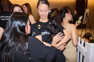 A woman petting a puppy at BC SPCA's Offleashed Vancouver Gala 2023