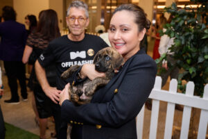 A woman holding a puppy at BC SPCA's Offleashed Vancouver Gala 2023