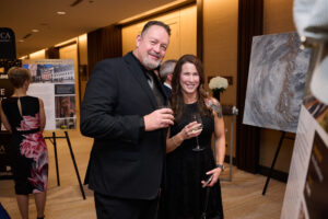 A couple between live auction items at BC SPCA's Offleashed Vancouver Gala 2023