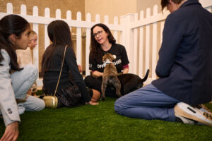 Children and a volunteer with a puppy at BC SPCA's Offleashed Vancouver Gala 2023