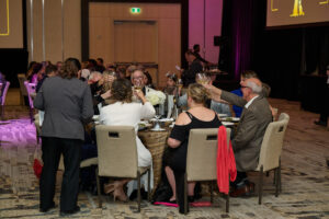 Guests at a table having a cheers at BC SPCA's Offleashed Vancouver Gala 2023